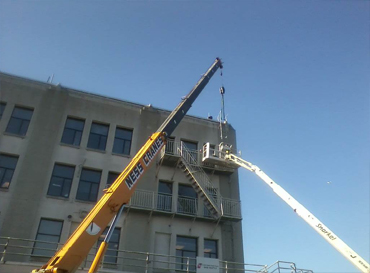 Two Cranes working on multi story building