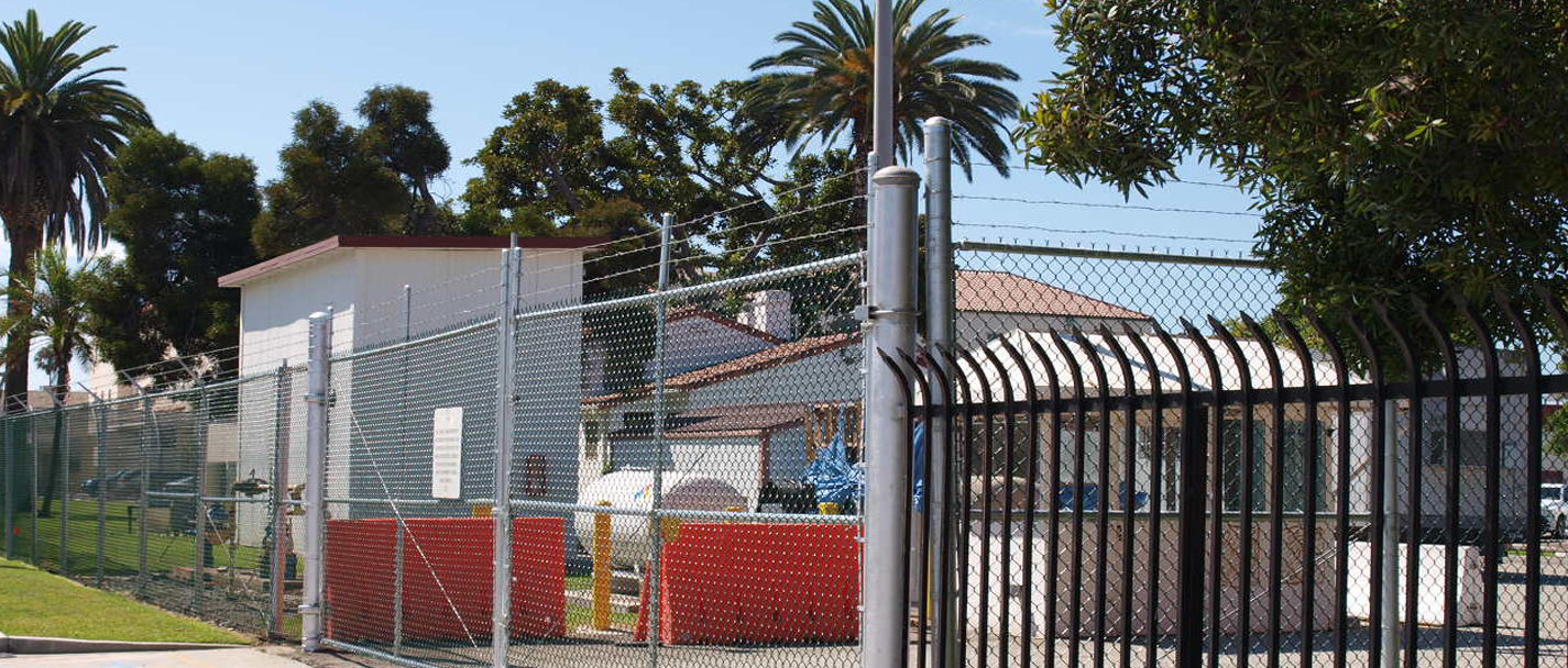 Chain Link / Iron Wrought Fence outside of  a compound